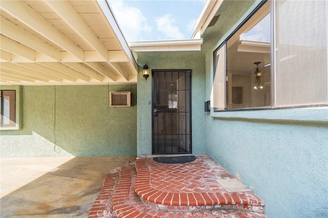 entrance to property featuring a patio