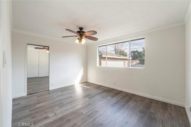 unfurnished room with hardwood / wood-style floors, crown molding, a textured ceiling, and ceiling fan