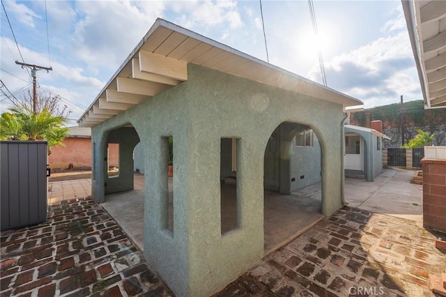 view of side of home with a patio area