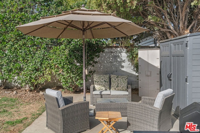 view of patio / terrace with a shed and an outdoor living space