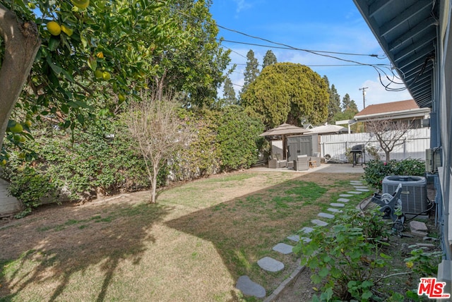 view of yard featuring a patio and central air condition unit