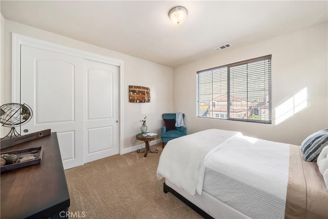 carpeted bedroom featuring a closet