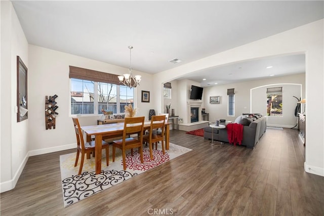 dining room with a notable chandelier and dark wood-type flooring