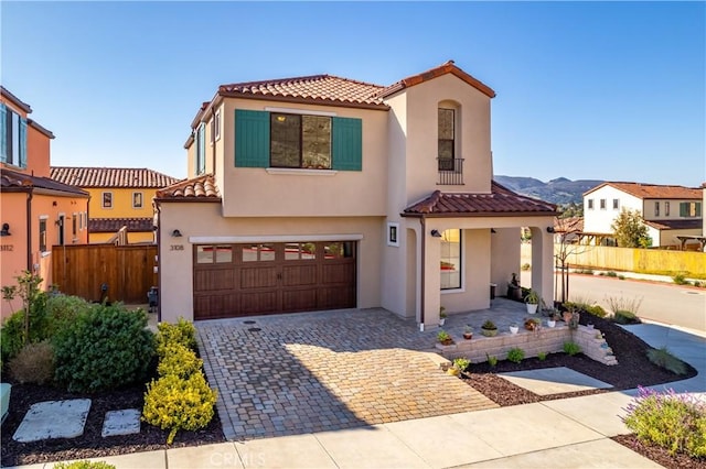 mediterranean / spanish-style house featuring a garage and a mountain view