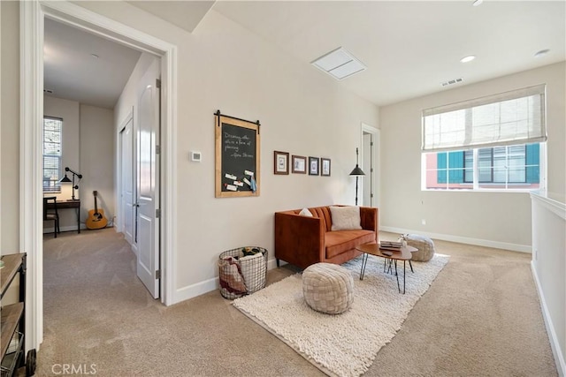 sitting room featuring light colored carpet