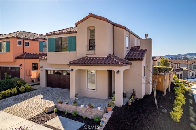 mediterranean / spanish-style home featuring a garage and a mountain view