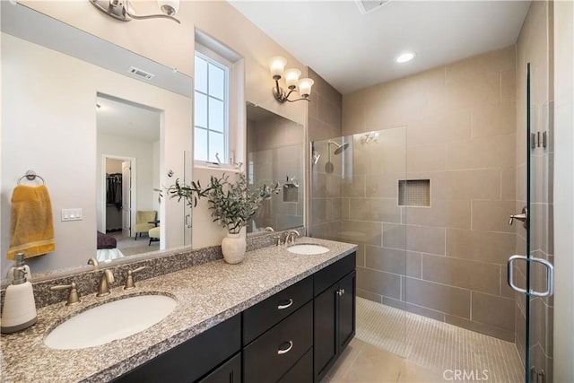 bathroom featuring vanity, an enclosed shower, and tile patterned floors