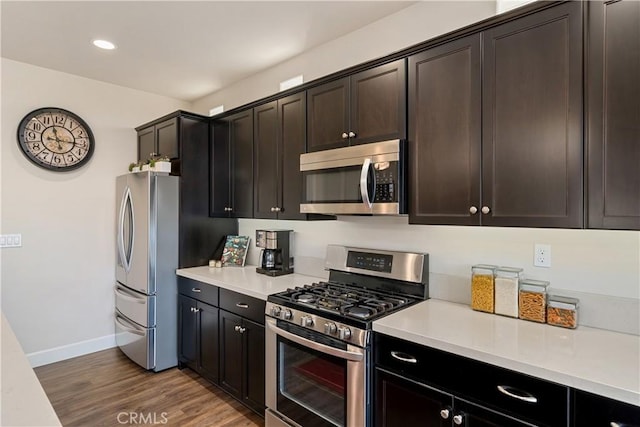 kitchen featuring appliances with stainless steel finishes, dark hardwood / wood-style floors, and dark brown cabinets