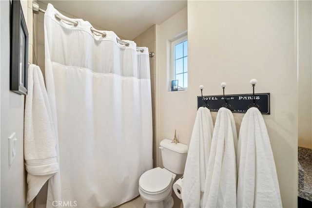 bathroom with walk in shower and toilet