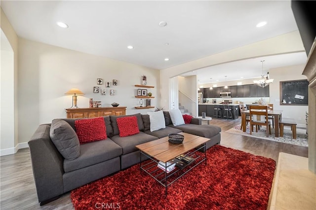 living room with wood-type flooring and a chandelier