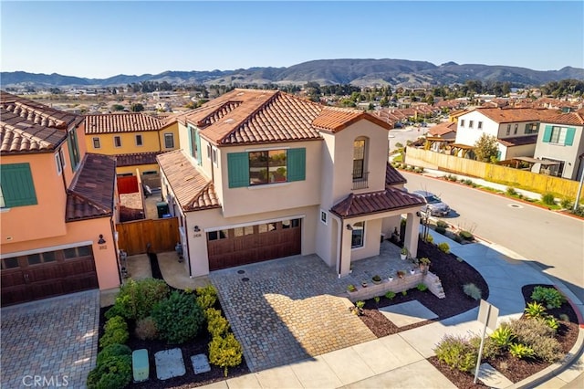 view of front of property with a mountain view and a garage