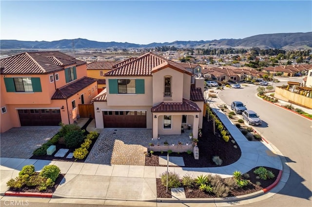 view of front of home featuring a garage and a mountain view