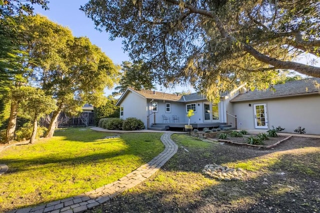 view of front of home featuring a front lawn and a deck