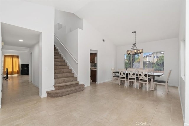 dining area with stairs, high vaulted ceiling, a chandelier, and baseboards