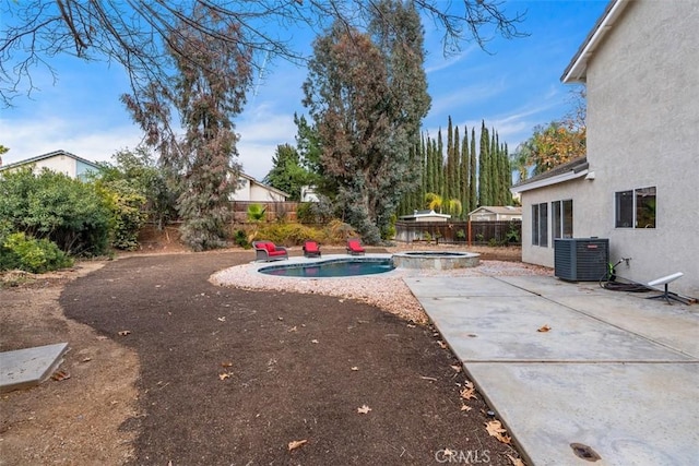 view of yard with a pool with hot tub, a patio area, and central air condition unit