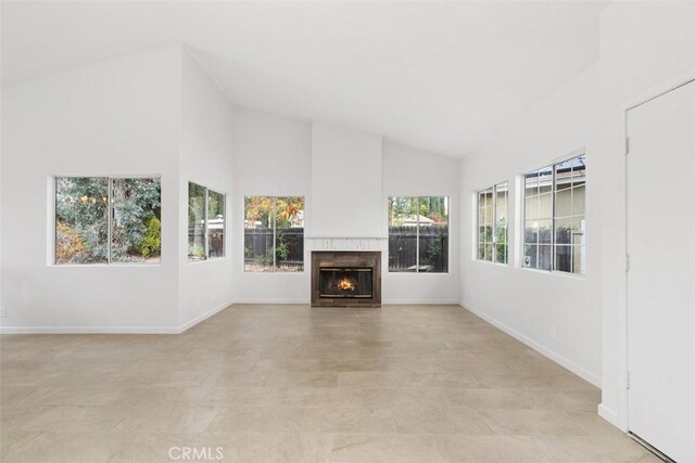 unfurnished living room featuring high vaulted ceiling