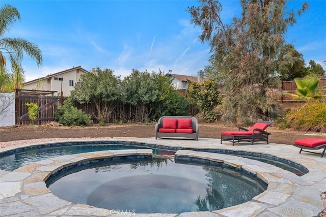 view of pool with an in ground hot tub and a patio