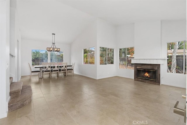 living room with a notable chandelier and high vaulted ceiling