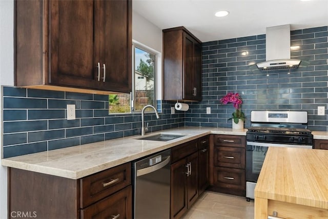 kitchen featuring extractor fan, sink, light tile patterned floors, stainless steel appliances, and light stone countertops