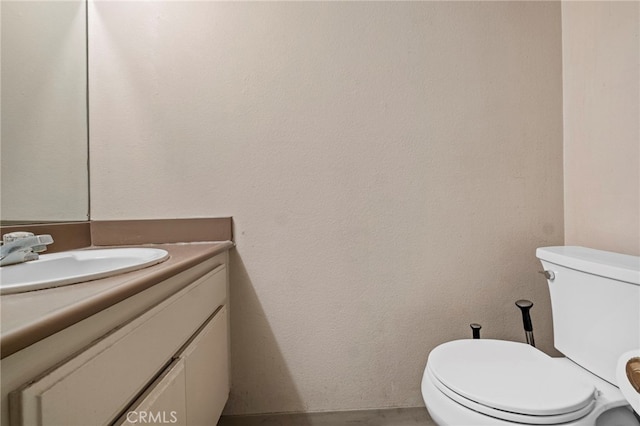 bathroom with toilet and vanity