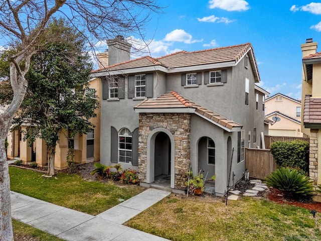 mediterranean / spanish-style home with a front lawn