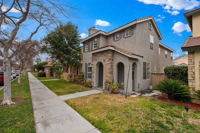 mediterranean / spanish-style home with a front lawn