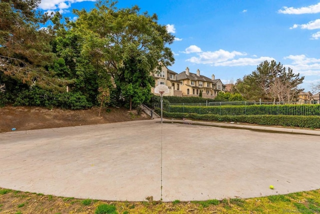 view of home's community featuring basketball hoop