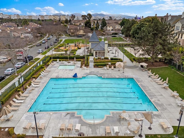 view of swimming pool featuring a mountain view and a patio area