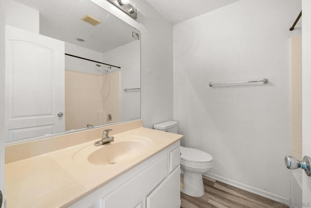 bathroom with wood-type flooring, vanity, and toilet