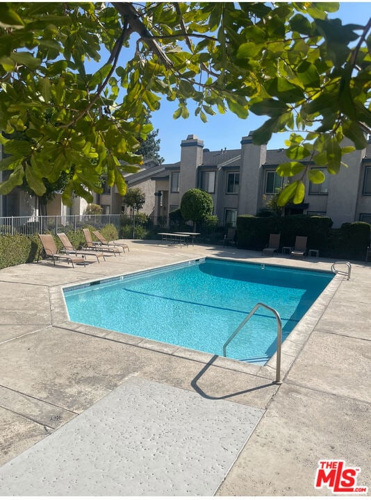 view of swimming pool with a patio area