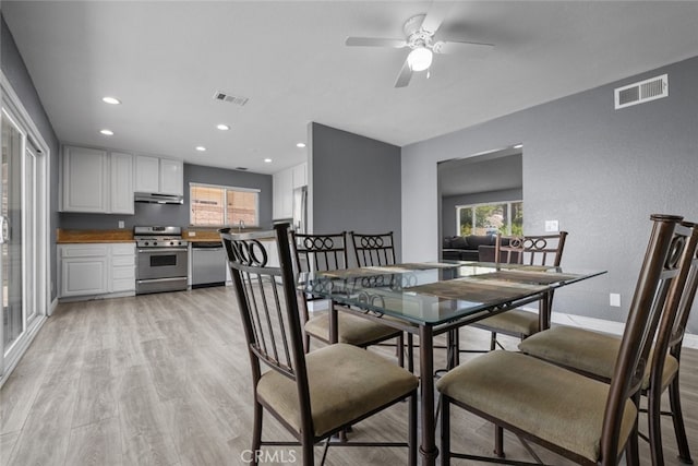 dining room featuring ceiling fan and light hardwood / wood-style flooring