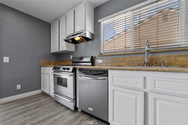 kitchen featuring sink, light wood-type flooring, white cabinets, and appliances with stainless steel finishes