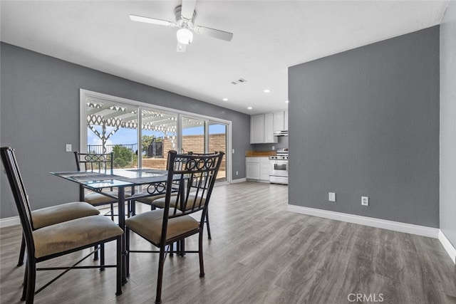 dining space featuring ceiling fan and light wood-type flooring