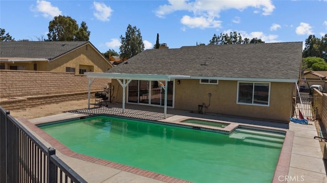 view of pool featuring a patio area and an in ground hot tub