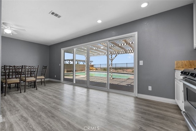 dining area featuring ceiling fan and wood-type flooring