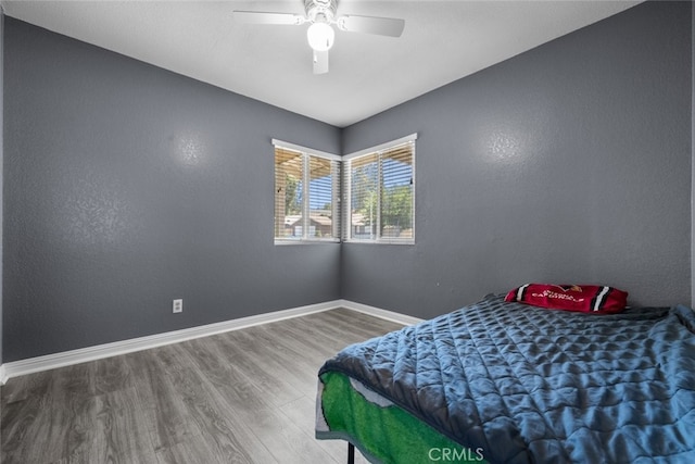 bedroom with hardwood / wood-style flooring and ceiling fan