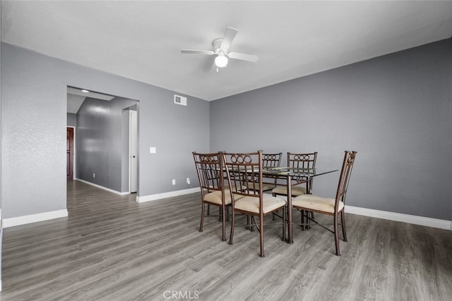 dining space with wood-type flooring and ceiling fan