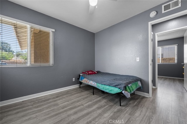 bedroom with ceiling fan and hardwood / wood-style floors