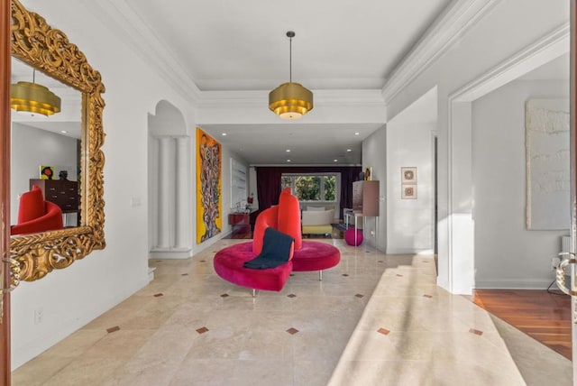 hallway featuring crown molding and decorative columns