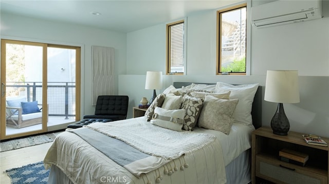 bedroom with wood-type flooring, access to exterior, a wall mounted AC, and multiple windows