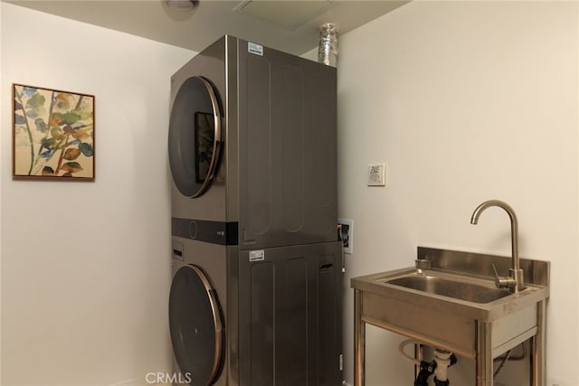 laundry room featuring stacked washing maching and dryer and sink