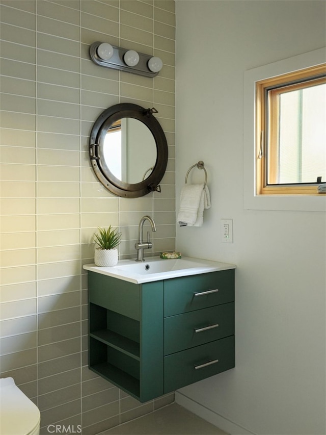 bathroom featuring vanity, toilet, and a wealth of natural light