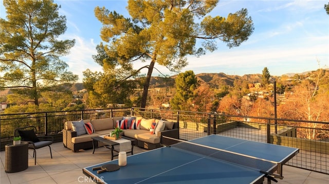 view of patio / terrace with an outdoor hangout area and a mountain view