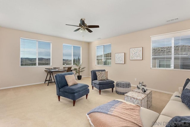 living room with ceiling fan and light colored carpet