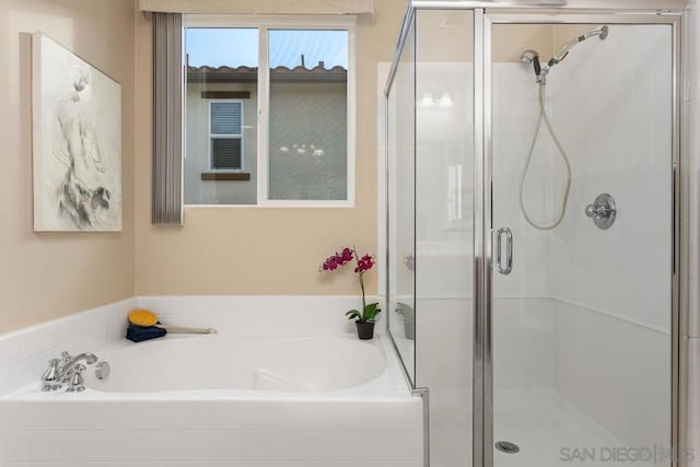 bathroom featuring independent shower and bath