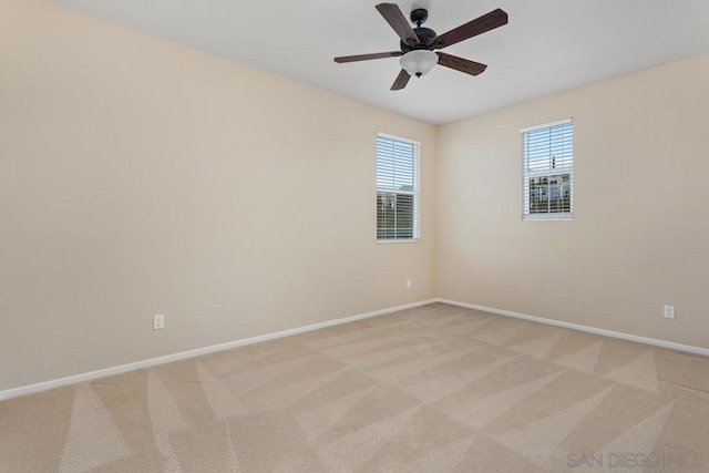 empty room with ceiling fan and light carpet