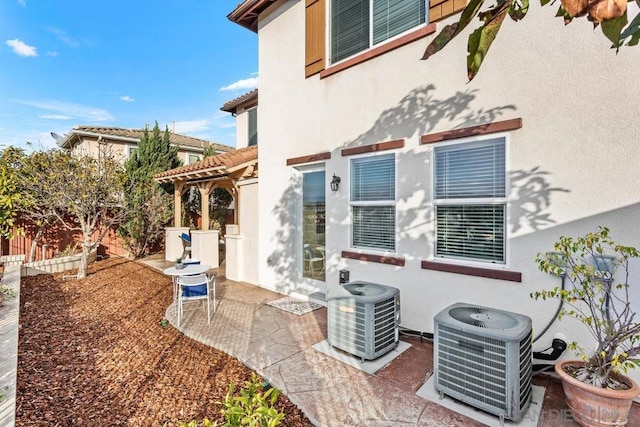 back of house featuring central AC and a patio area