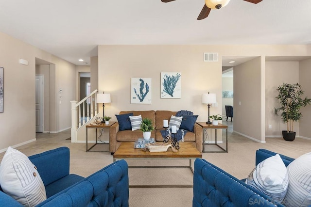 living room featuring ceiling fan and light colored carpet