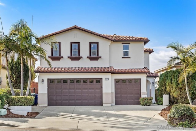 mediterranean / spanish house featuring a garage