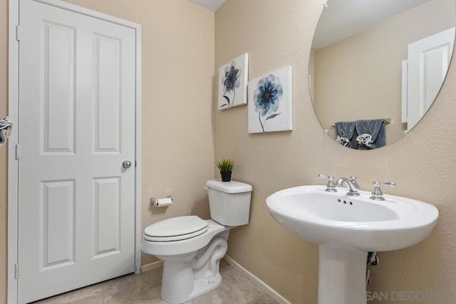 bathroom with tile patterned flooring and toilet